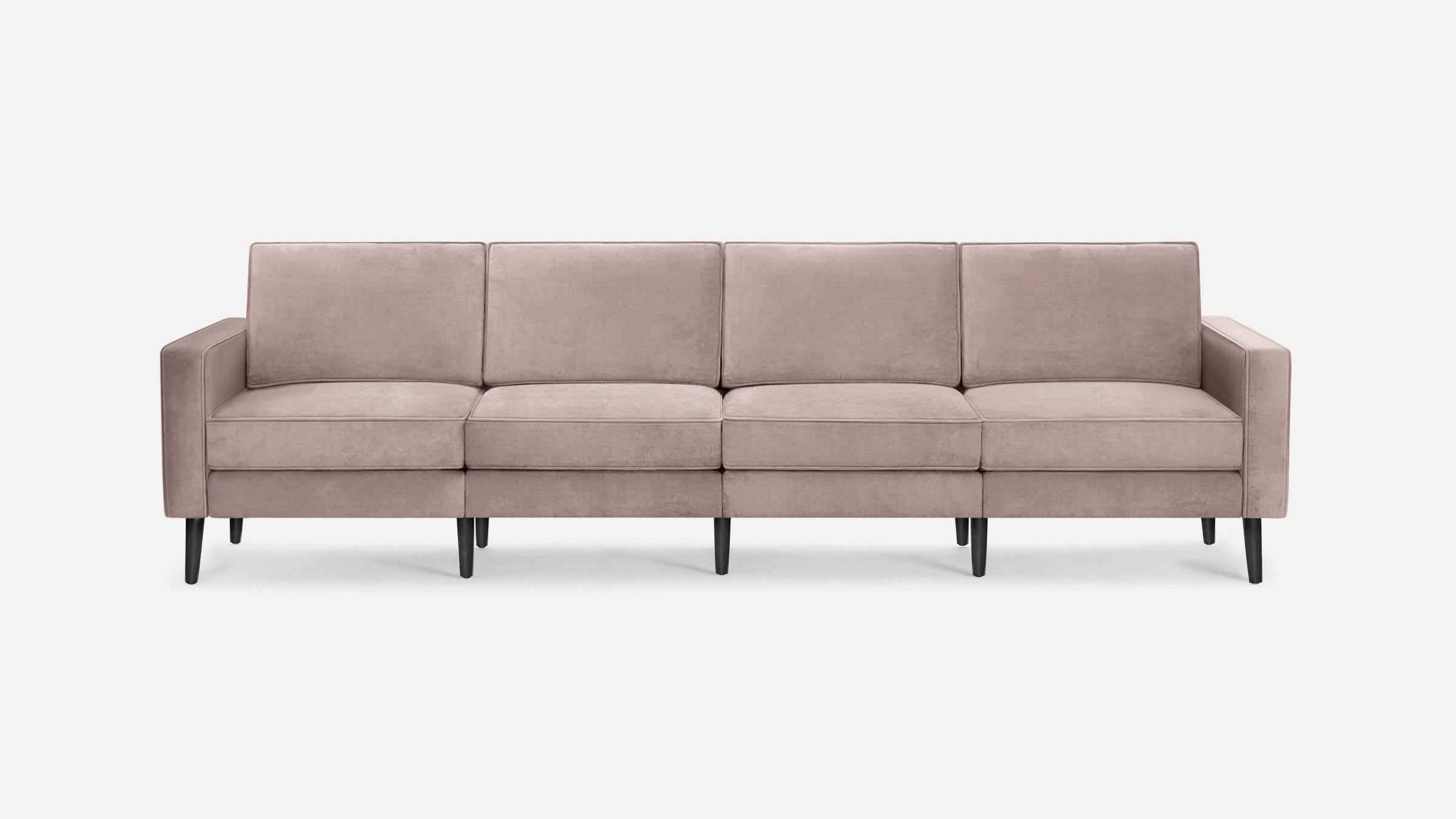 Modern four-seater sofa in soft mauve fabric with straight arms and tapered black legs on a white background.