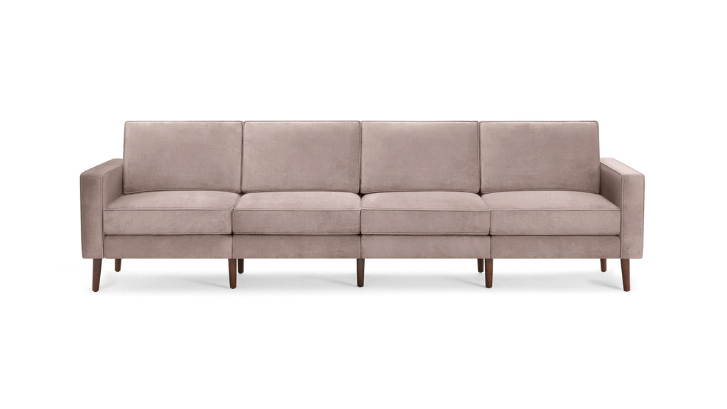 modern light pink velvet sofa with wooden legs and clean lines on the back, featuring a clean, minimalist design