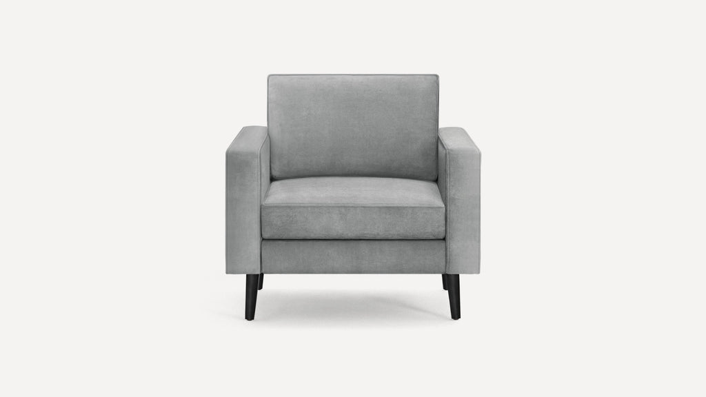 Modern gray fabric armchair with straight armrests, cushioned seat and backrest, supported by four black wooden legs.