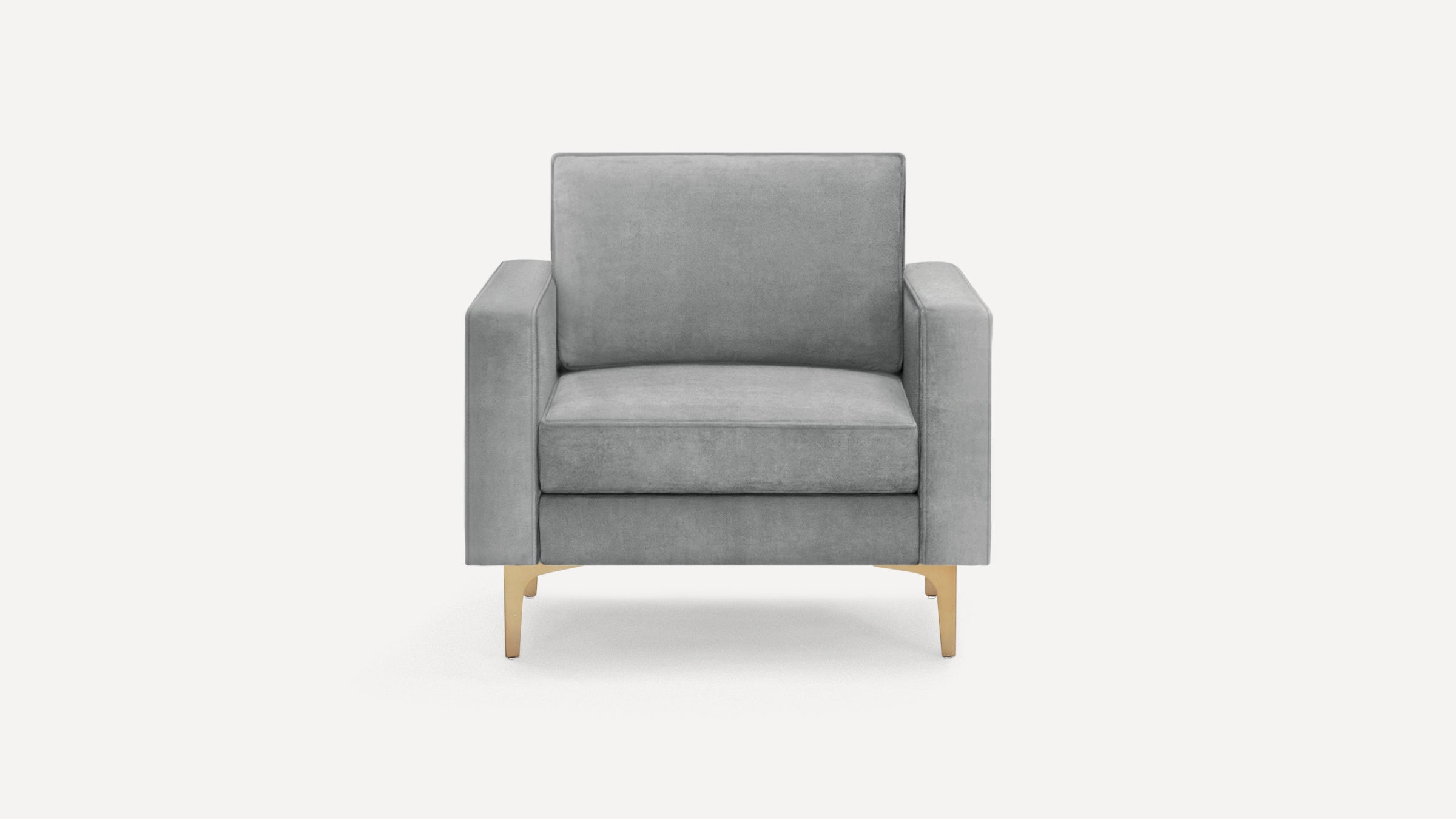 Modern grey velvet armchair with square arms and gold metal legs, pictured on a white background.
