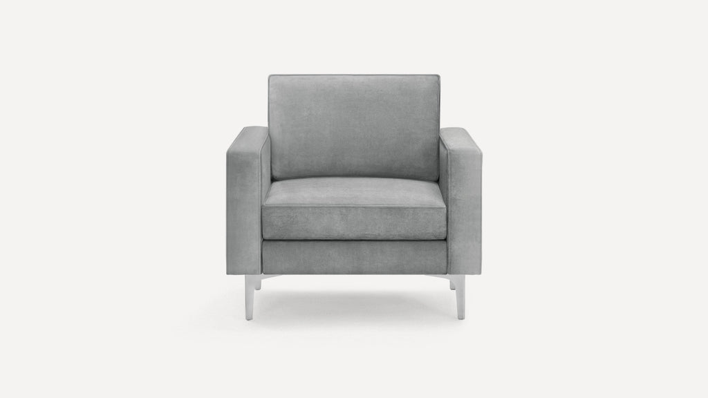 Front view of a modern gray upholstered armchair with straight arms and metal legs on a white background.