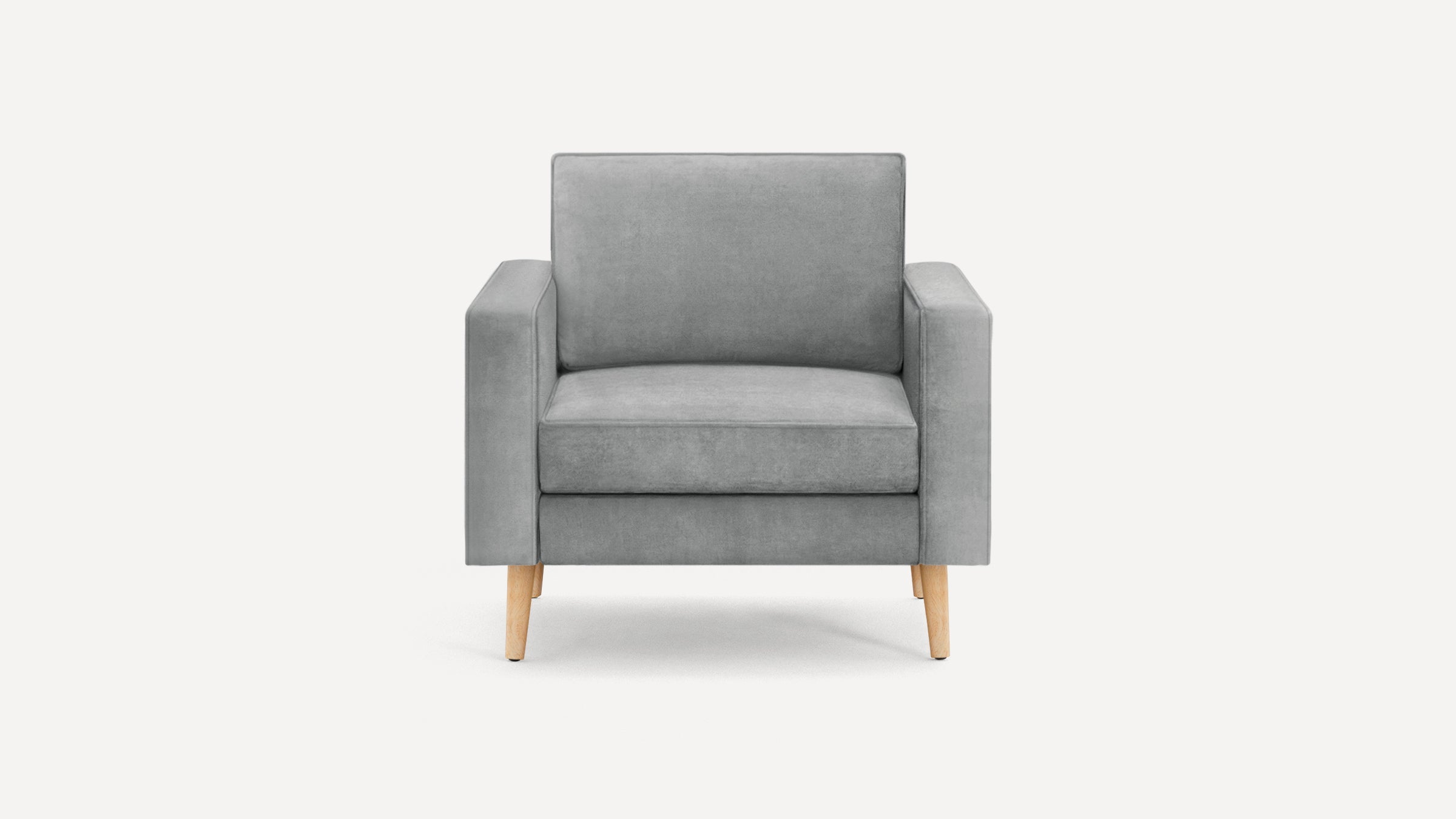 Front view of a modern gray upholstered armchair with wooden tapered legs on a white background.