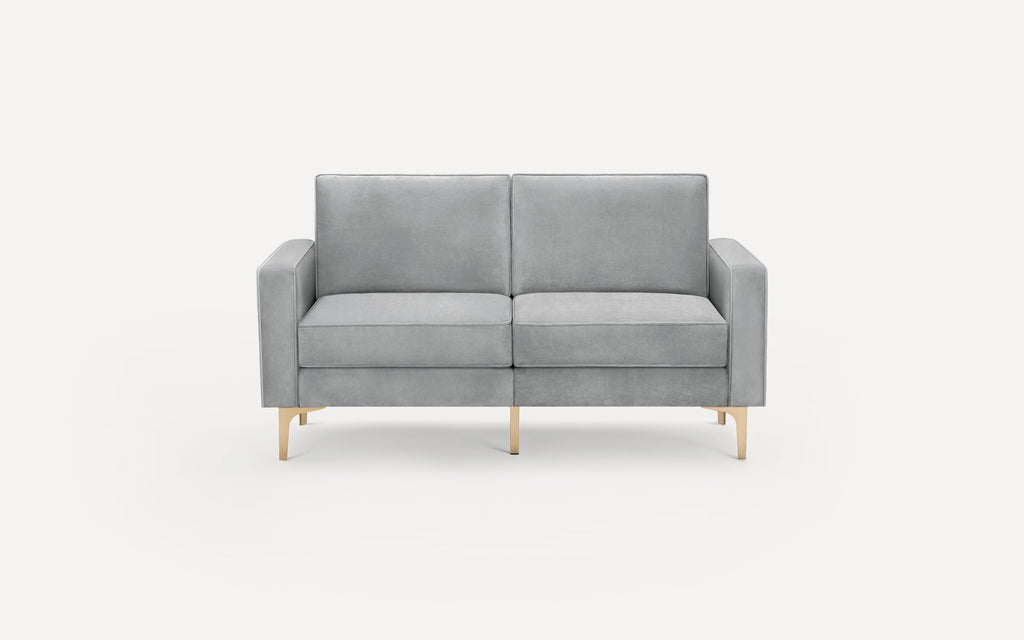 Modern two-seater sofa upholstered in light gray fabric with clean lines and slender gold metal legs.