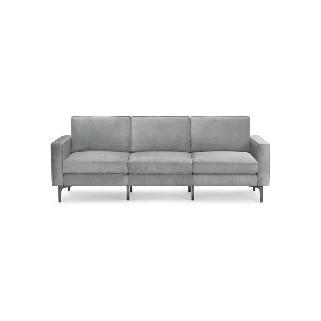 modern gray velvet sofa with black legs and back cushions