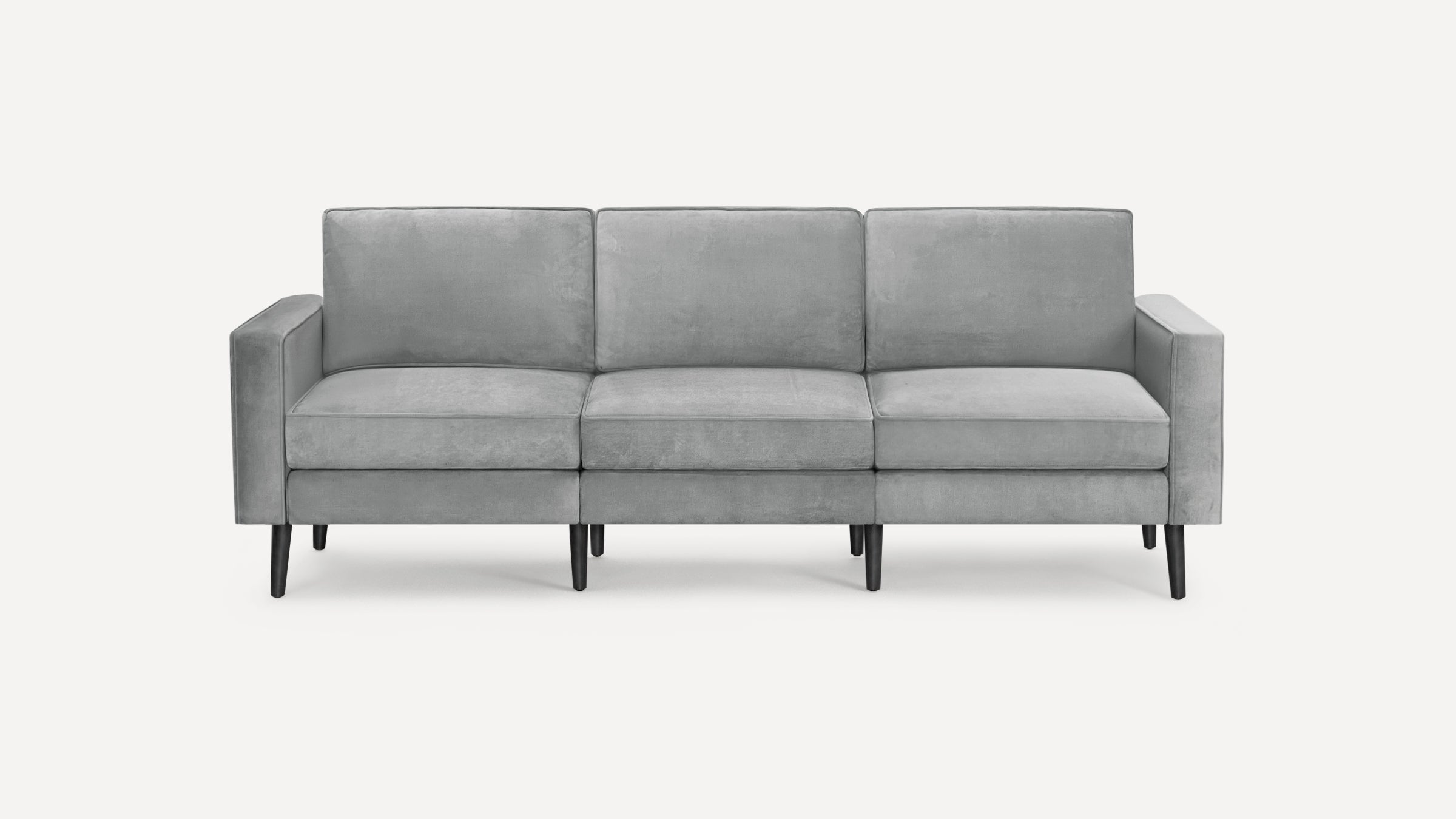 Modern three-seater sofa with light gray upholstery and black tapered legs, featuring clean lines and rectangular cushions.