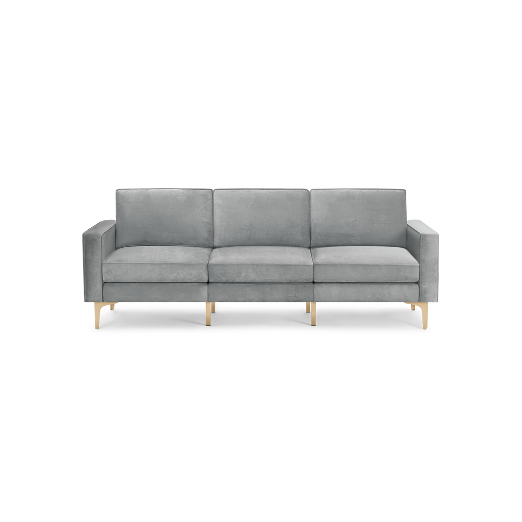modern light gray velvet sofa with wooden legs and back cushions, featuring a sleek design and clean lines