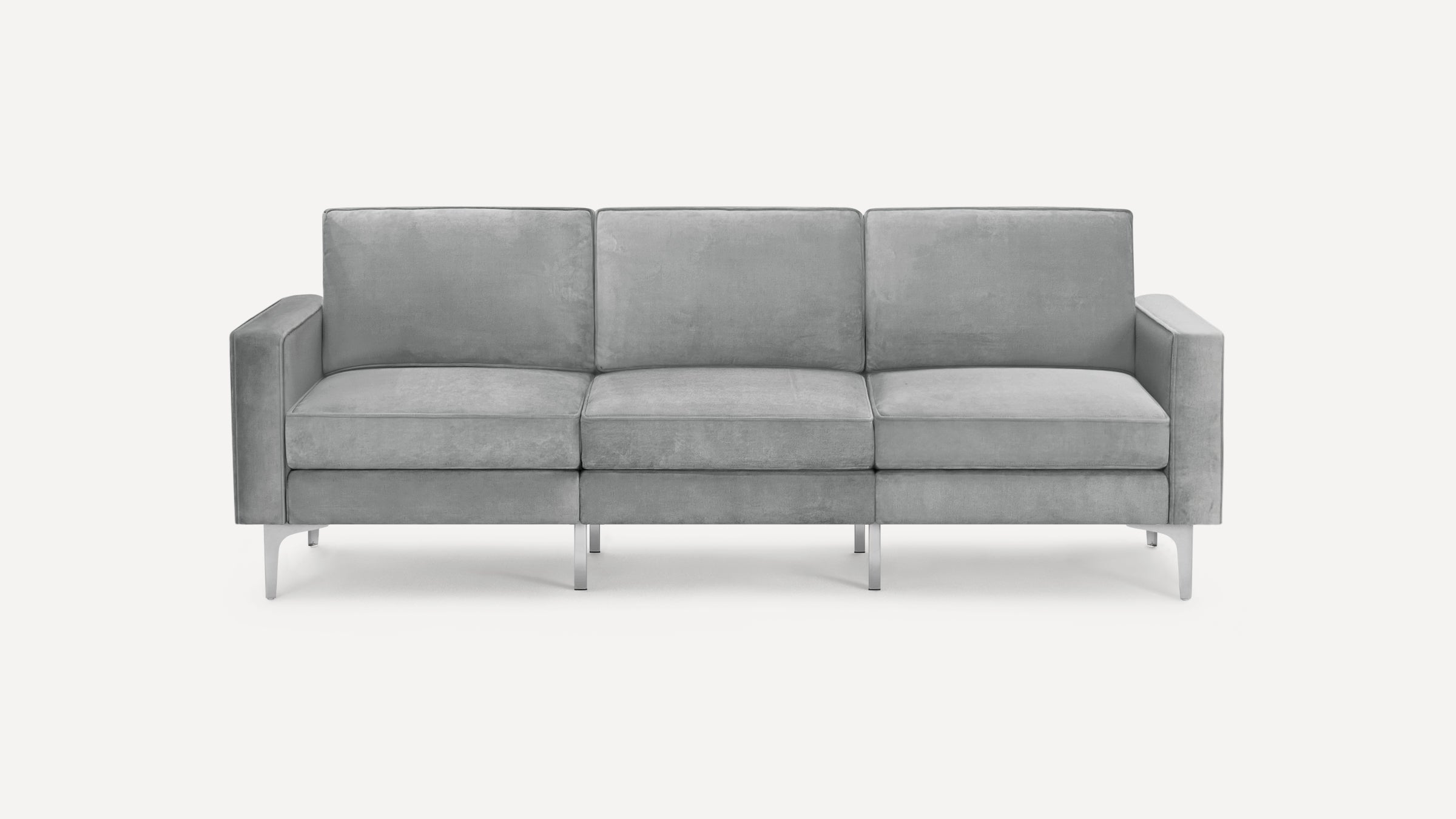 Modern three-seater sofa with soft grey upholstery, clean lines, square armrests, and slim metal legs.