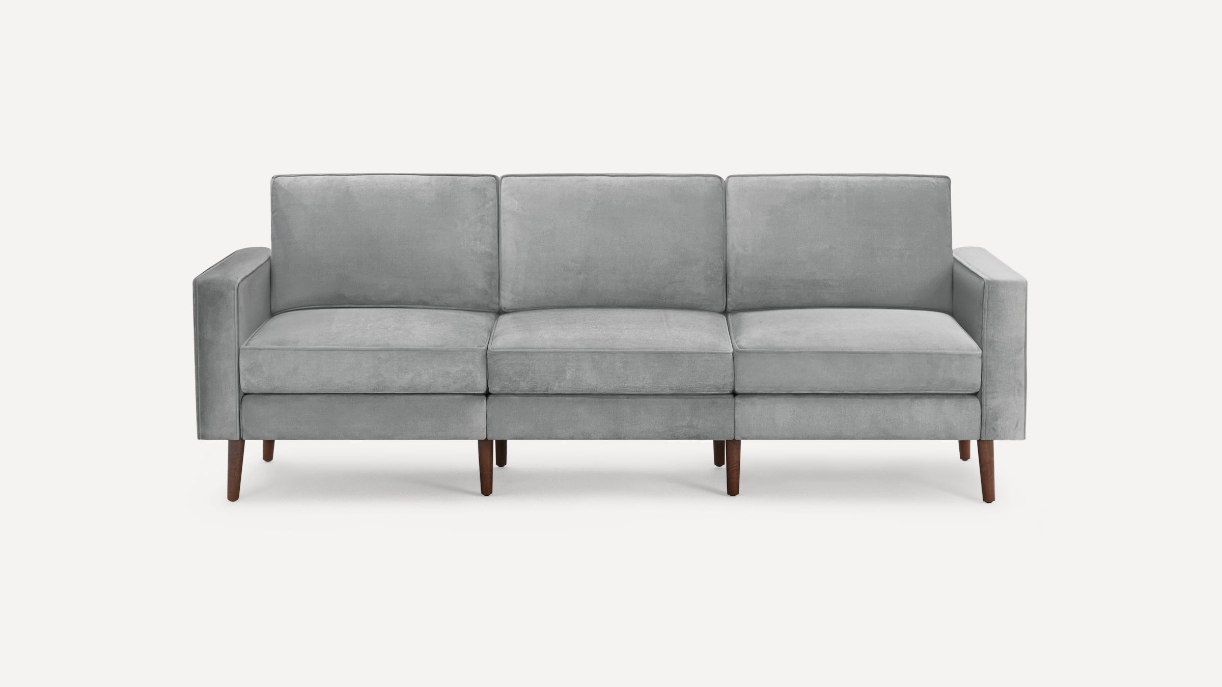 Modern three-seater sofa with light gray fabric upholstery and tapered wooden legs, featuring clean lines and square armrests.