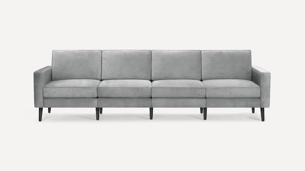 Modern light gray four-seater sofa with straight arms, cushioned backs, and dark tapered wooden legs on a white background.