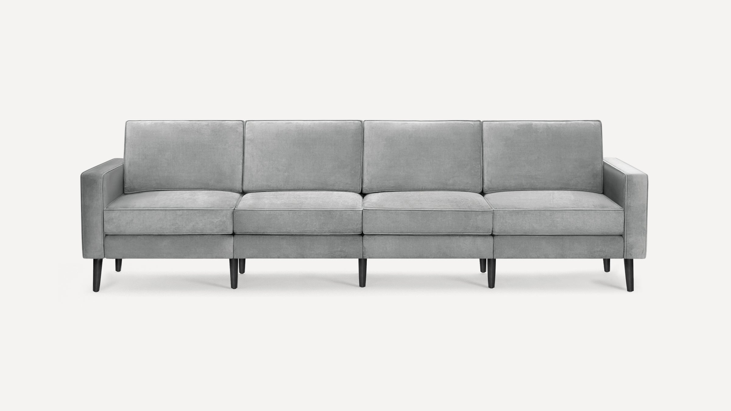 Modern light gray four-seater sofa with straight arms, cushioned backs, and dark tapered wooden legs on a white background.