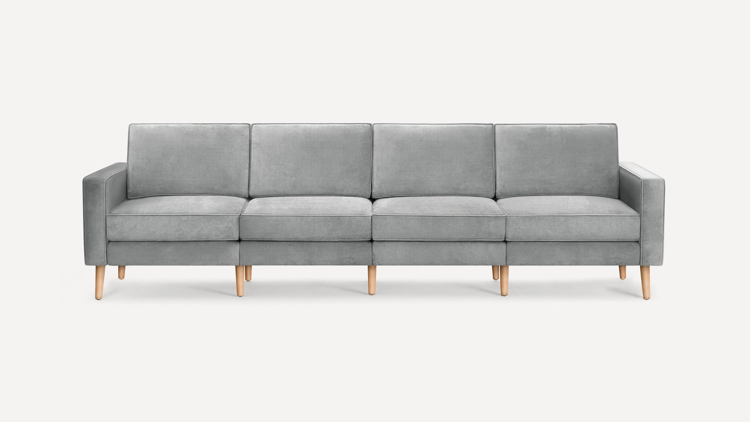 Four-seater modern gray fabric sofa with clean lines, wooden legs, and cushioned back and seat for comfort.