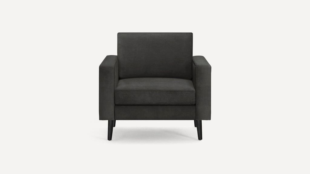 Modern black armchair with clean lines, cushioned seat and backrest, and slender tapered legs, shown from front view.