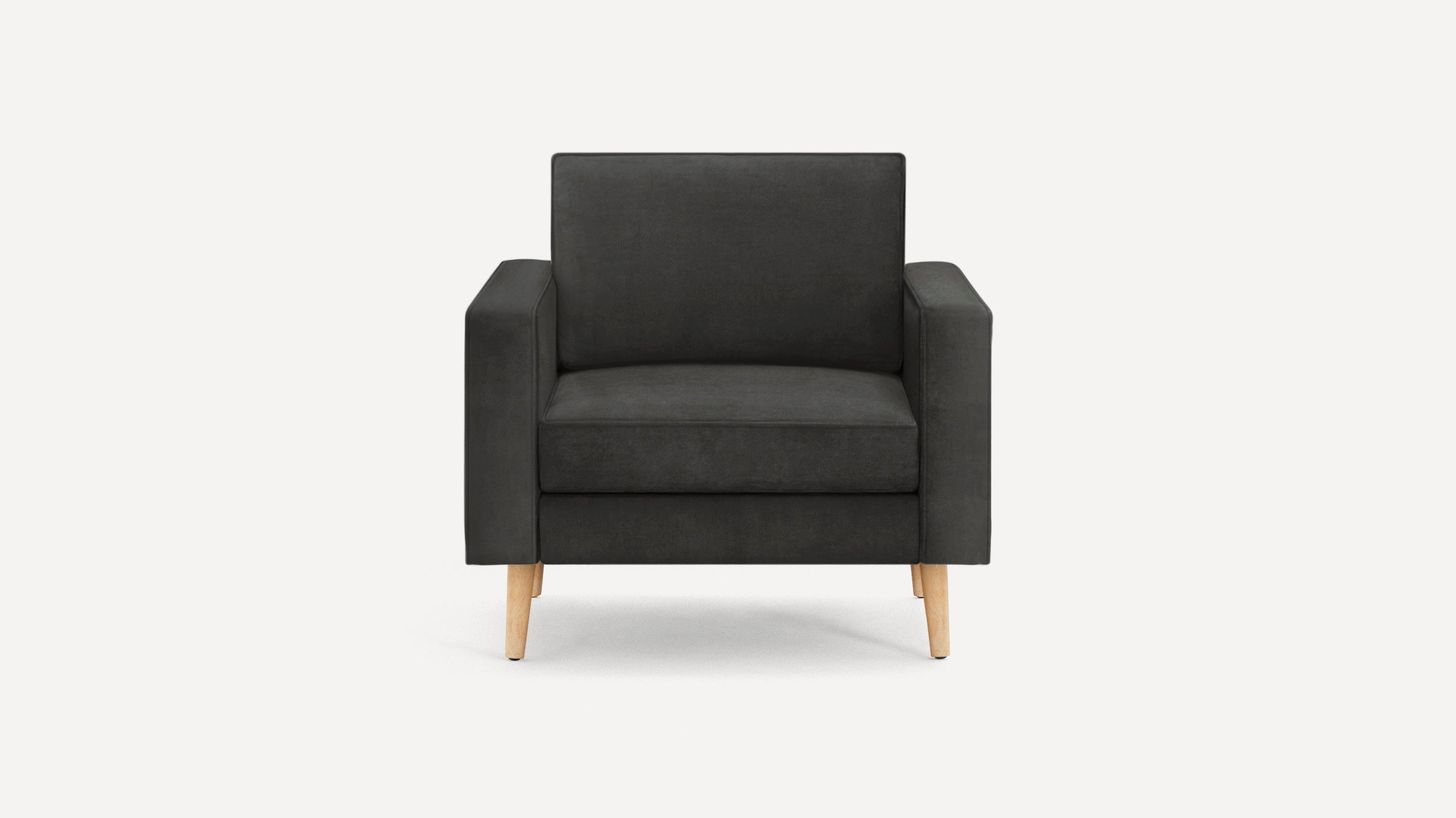 Modern dark gray upholstered armchair with boxy frame, cushioned seat and back, and four natural wood angled legs.