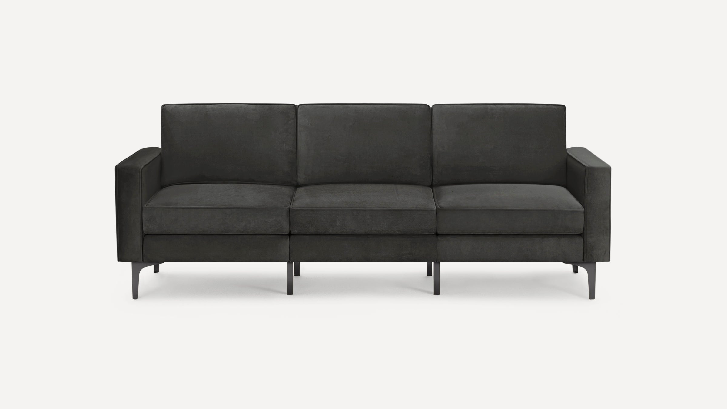 Modern dark gray three-seater sofa with clean lines, plush cushions, and slim metal legs, against a white background.