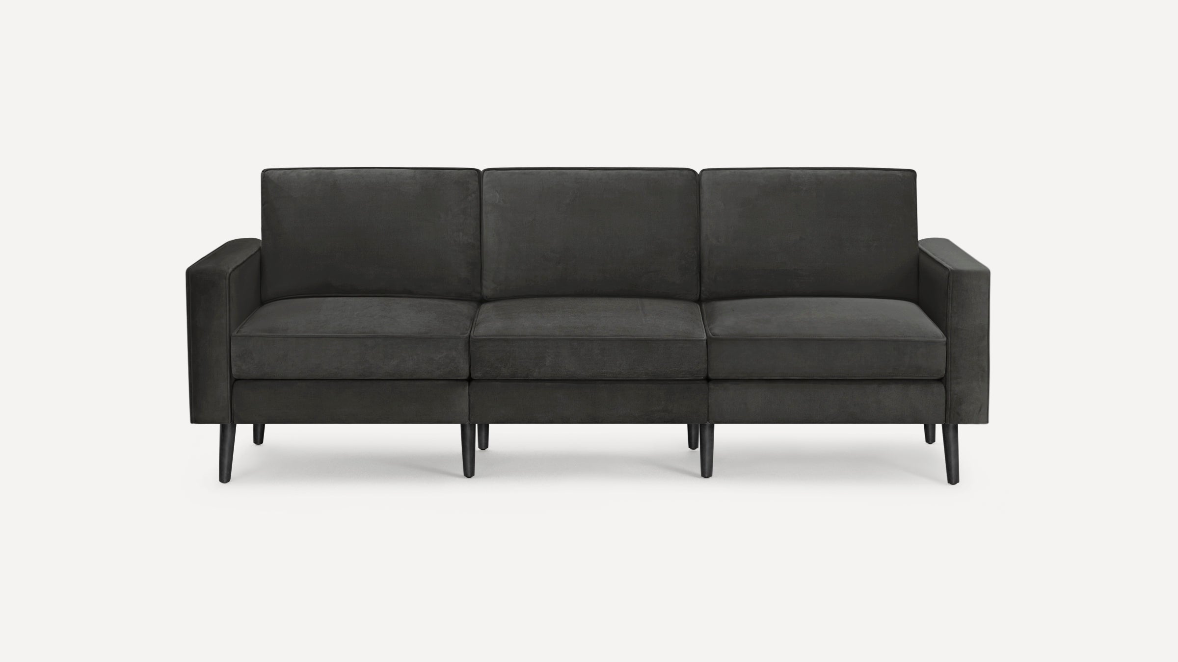 Modern three-seater sofa with dark gray fabric upholstery, straight arms, cushioned backrests, and tapered black wooden legs.