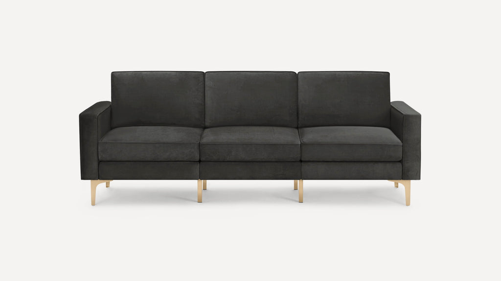 Modern black three-seater sofa with plush cushions, straight armrests, and gold-colored metal legs on a white background.