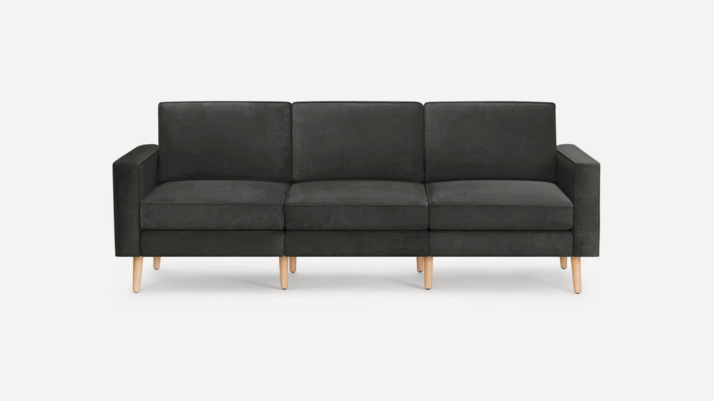 Modern dark gray three-seater sofa with square arms and light wooden legs, set against a plain white background.