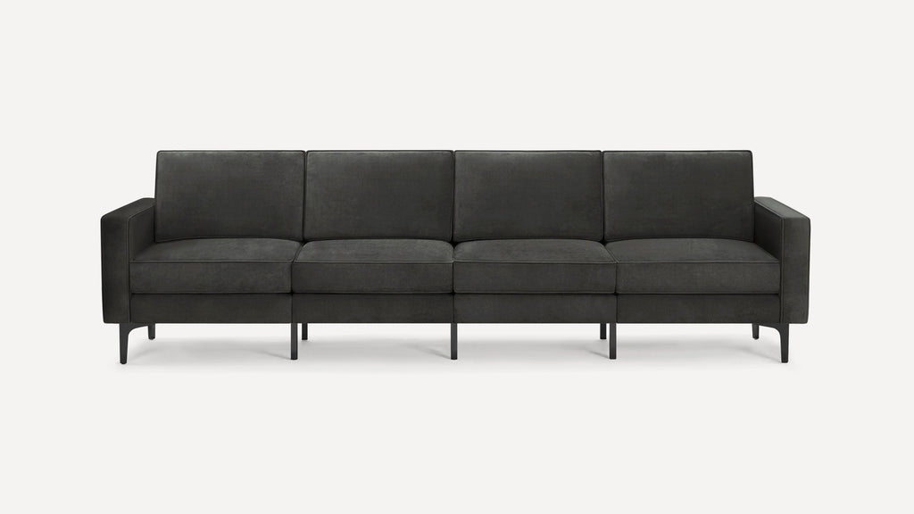 Dark gray modern four-seater sofa with clean lines, box cushions, and slim black metal legs on a white background.