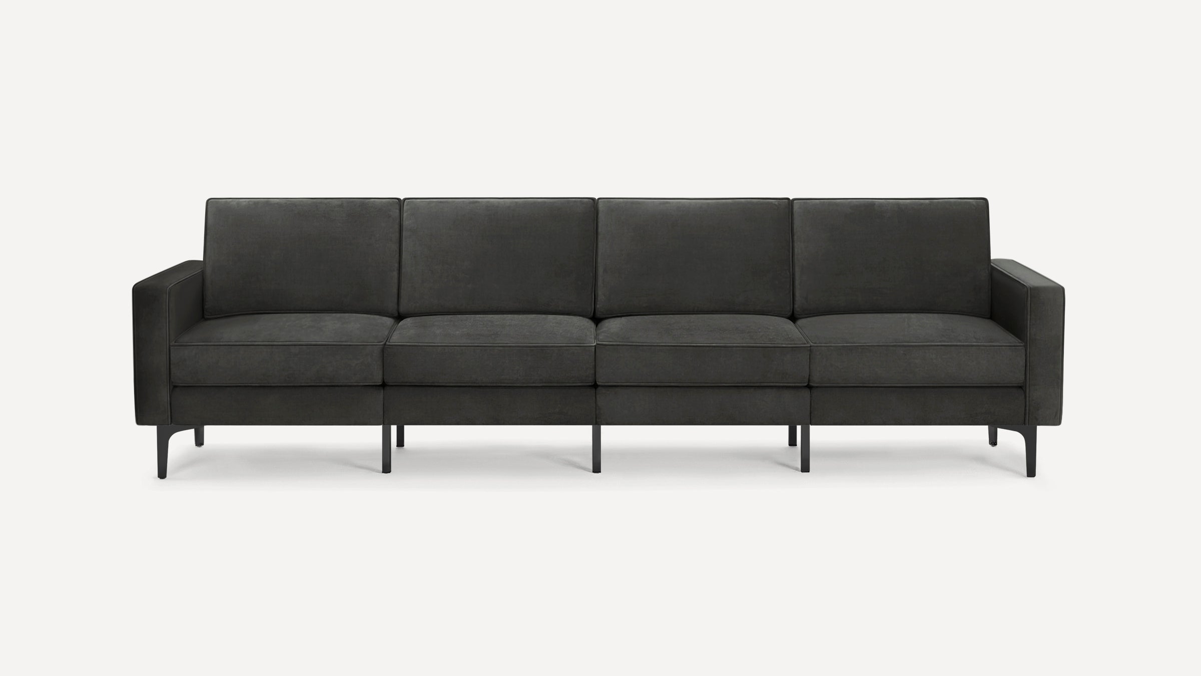 Dark gray modern four-seater sofa with clean lines, box cushions, and slim black metal legs on a white background.