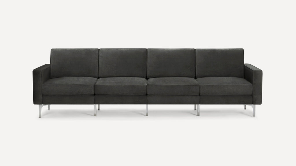 Dark gray modern four-seat sofa with clean lines, rectangular cushions, and metal legs, set against a plain white background.
