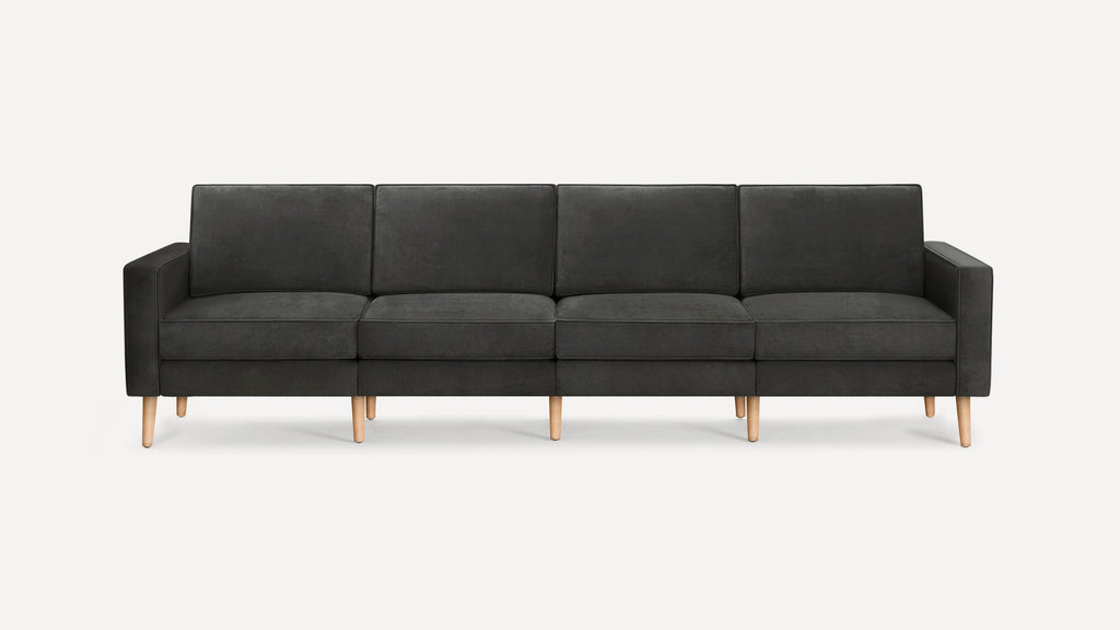 Modern four-seater dark gray fabric sofa with straight arms and light wooden legs, set against a plain white background.