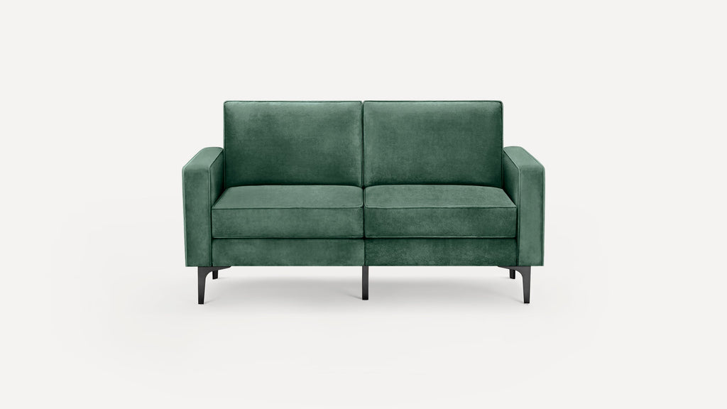 Green velvet two-seater sofa with straight arms and black tapered metal legs on a plain white background.