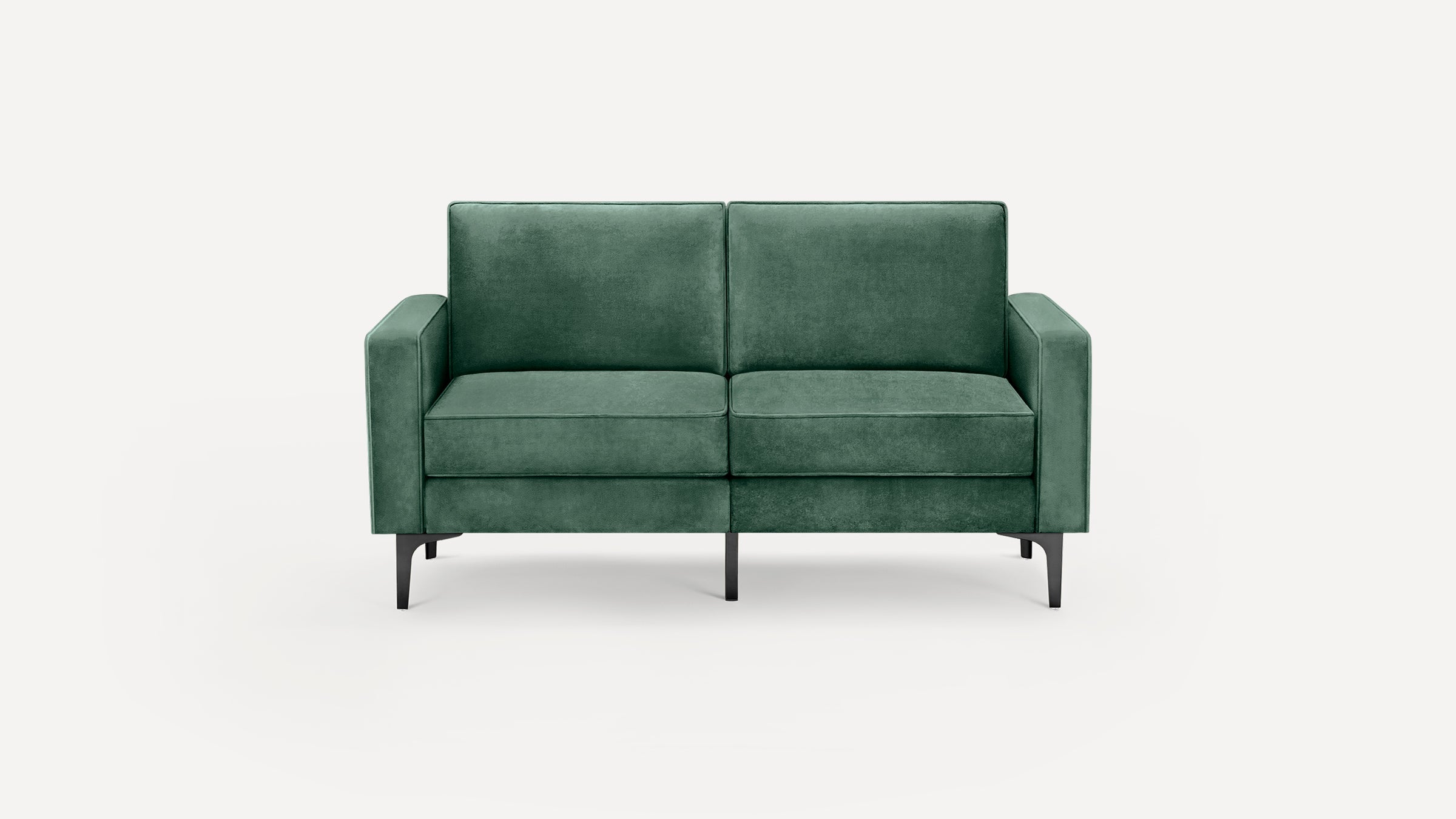 Green velvet two-seater sofa with straight arms and black tapered metal legs on a plain white background.