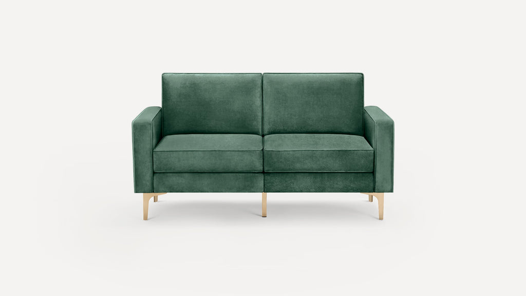 Green velvet two-seater sofa with square arms and slim gold metal legs, set against a plain white background.