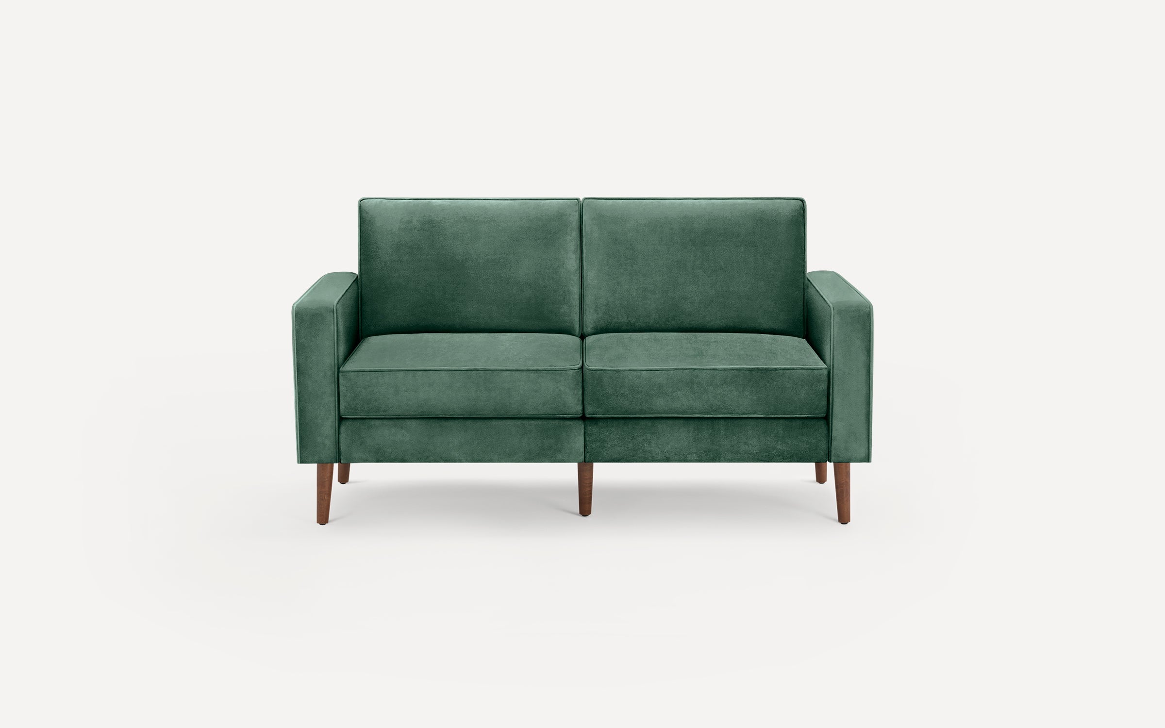 Green velvet two-seater sofa with clean lines, square arms, and tapered wooden legs, set against a white background.
