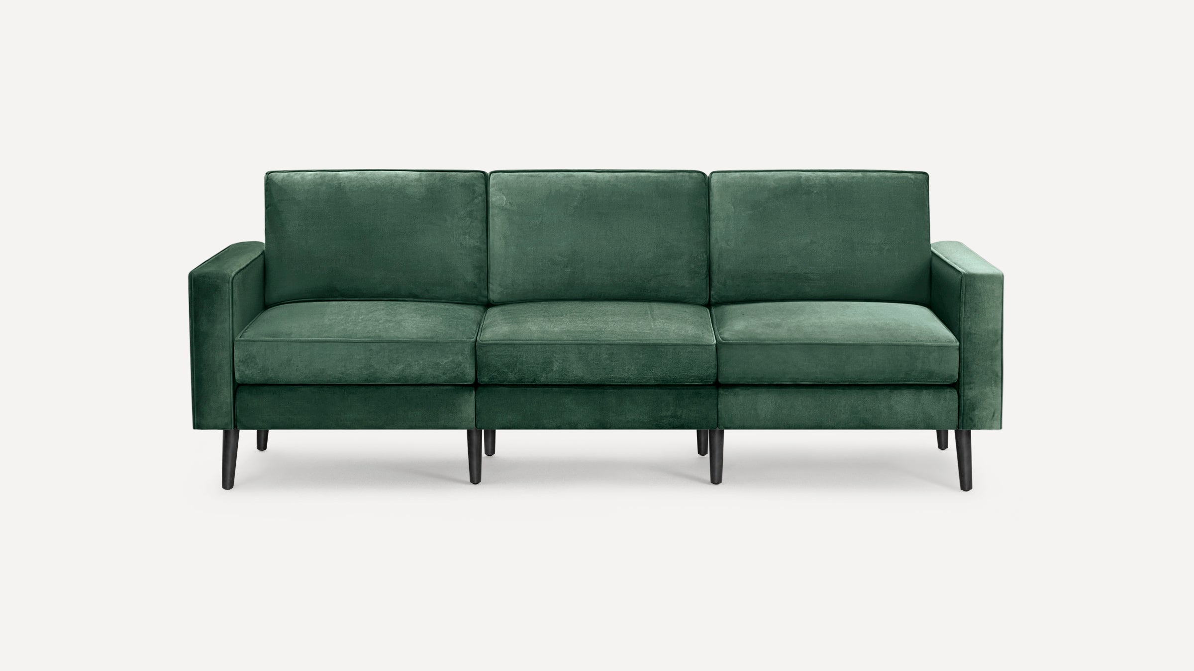 Modern three-seater sofa upholstered in dark green velvet fabric with clean lines, square arms, and black tapered wooden legs.