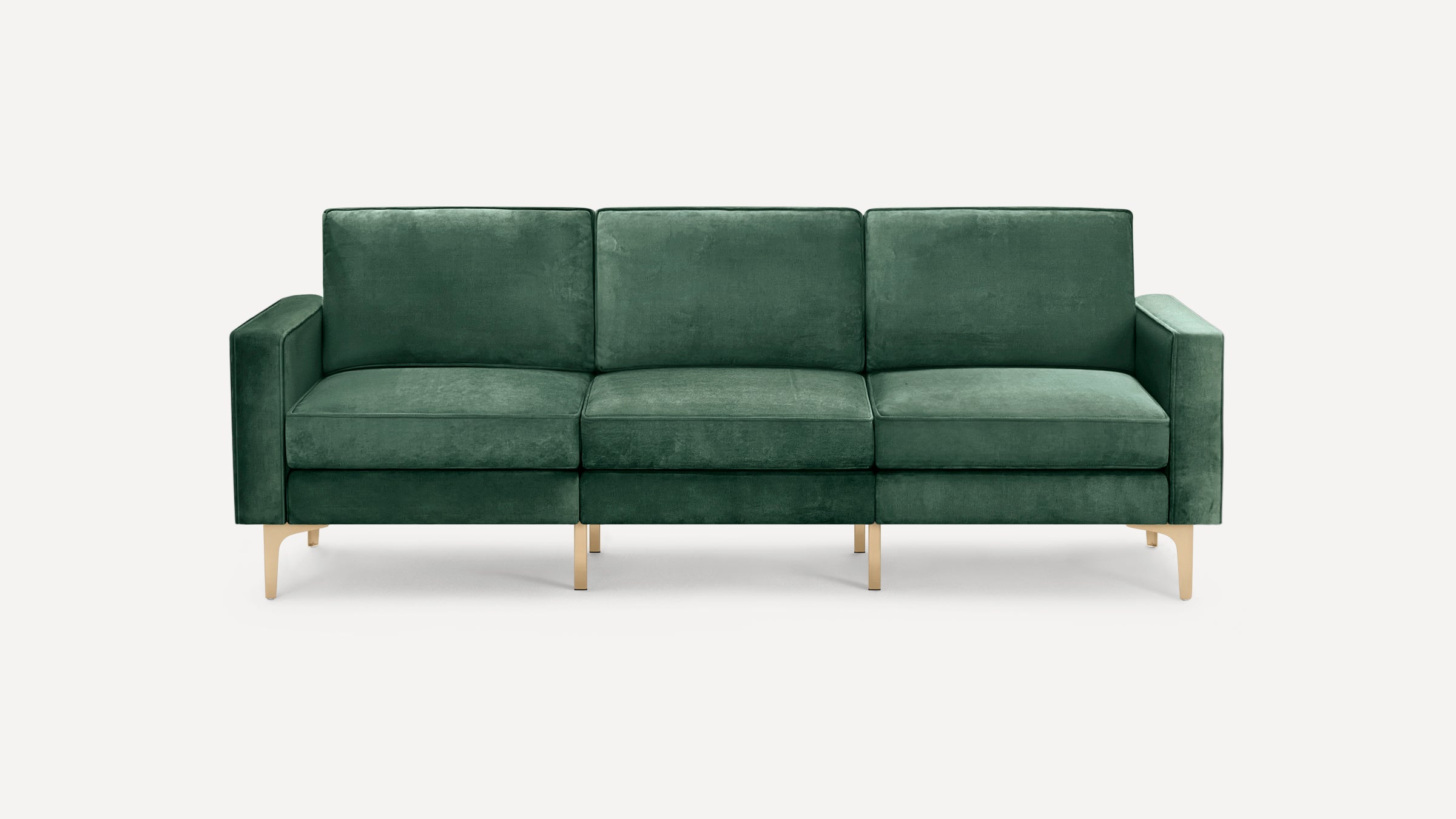 Modern three-seat sofa upholstered in deep green velvet fabric with clean lines and slender gold metal legs, set against a plain light background.