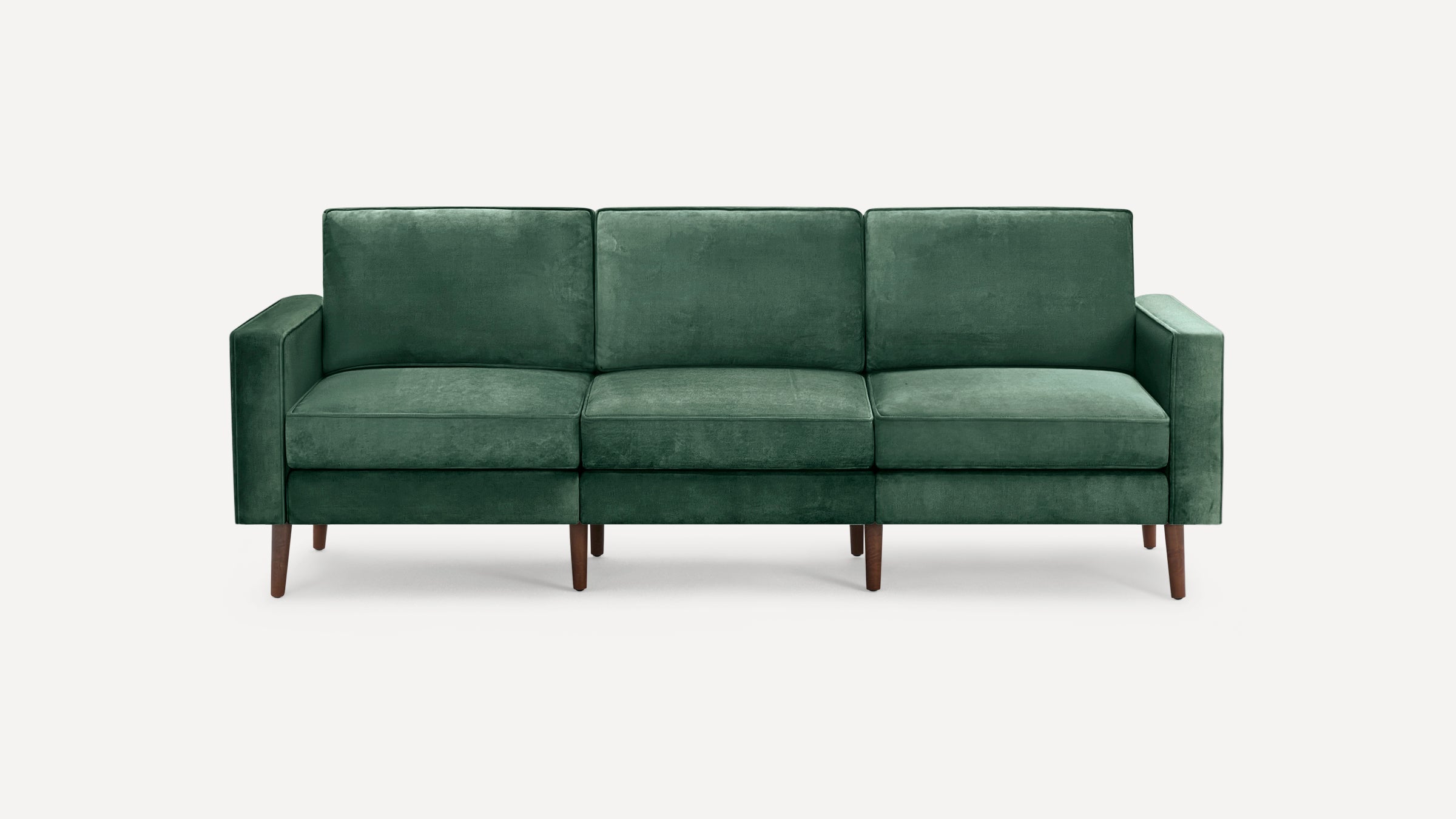 Three-seater green velvet sofa with clean lines, square arms, and mid-century style wooden legs.