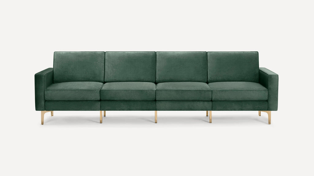 Dark green velvet modern four-seat sofa with square cushions and gold metal legs on a white background.