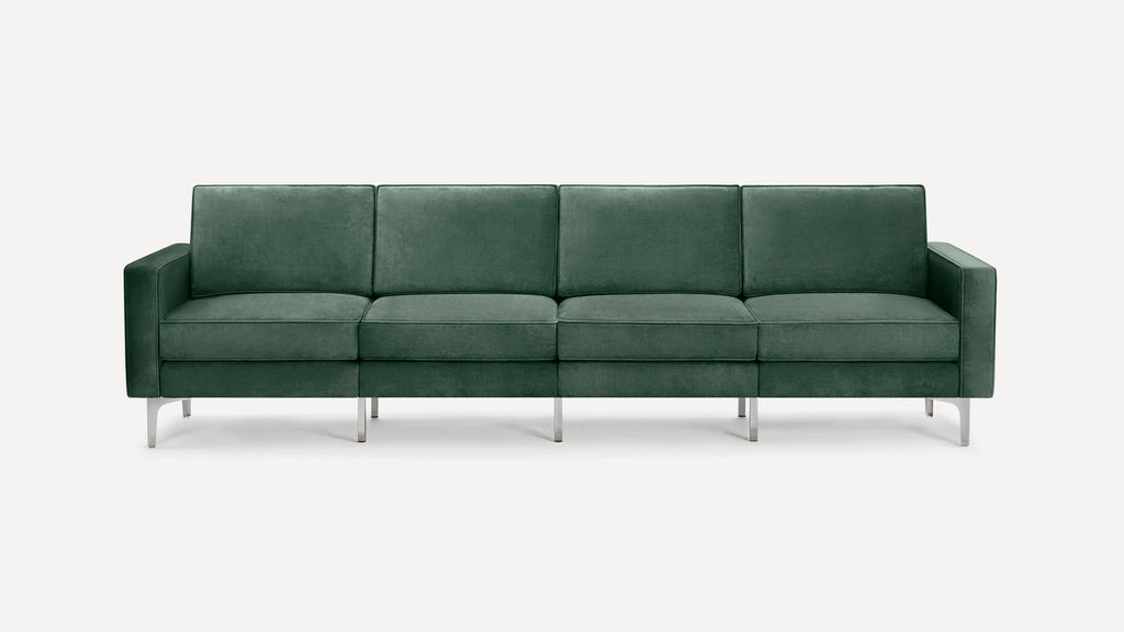 Modern four-seater sofa in dark green velvet upholstery with slim metal legs and clean, straight armrests.