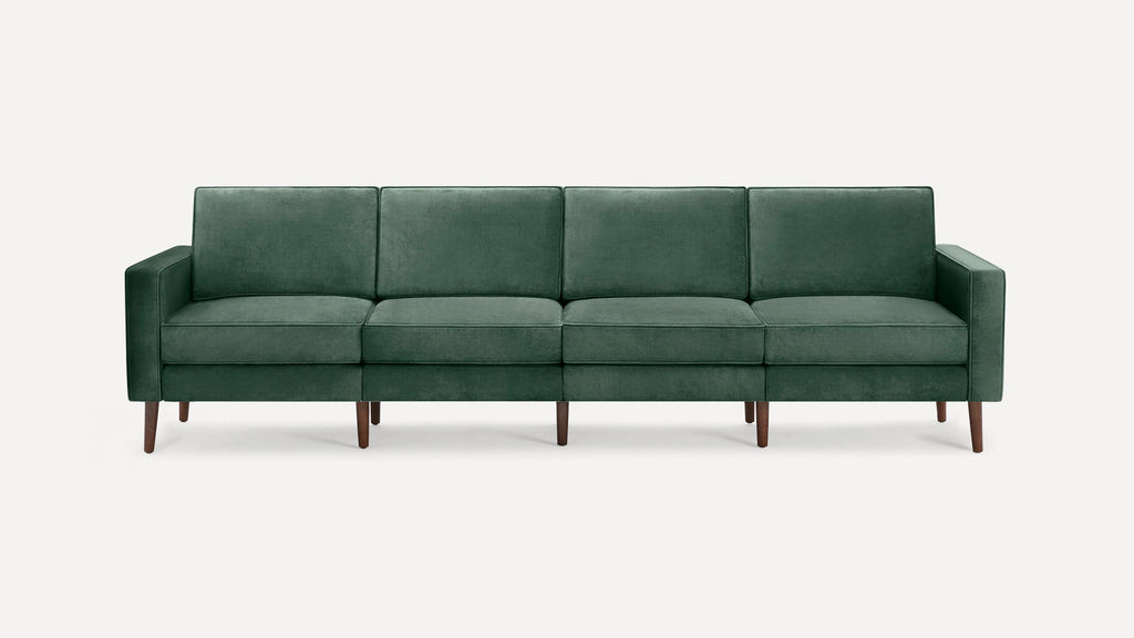 Modern four-seater sofa with dark green velvet upholstery and slim wooden legs, featuring clean lines and square armrests.