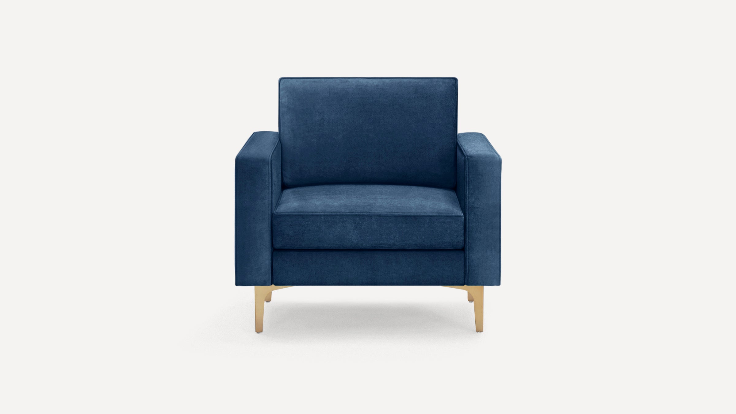 Modern navy blue velvet armchair with clean lines, rectangular cushions, and slender gold metal legs against a white background.