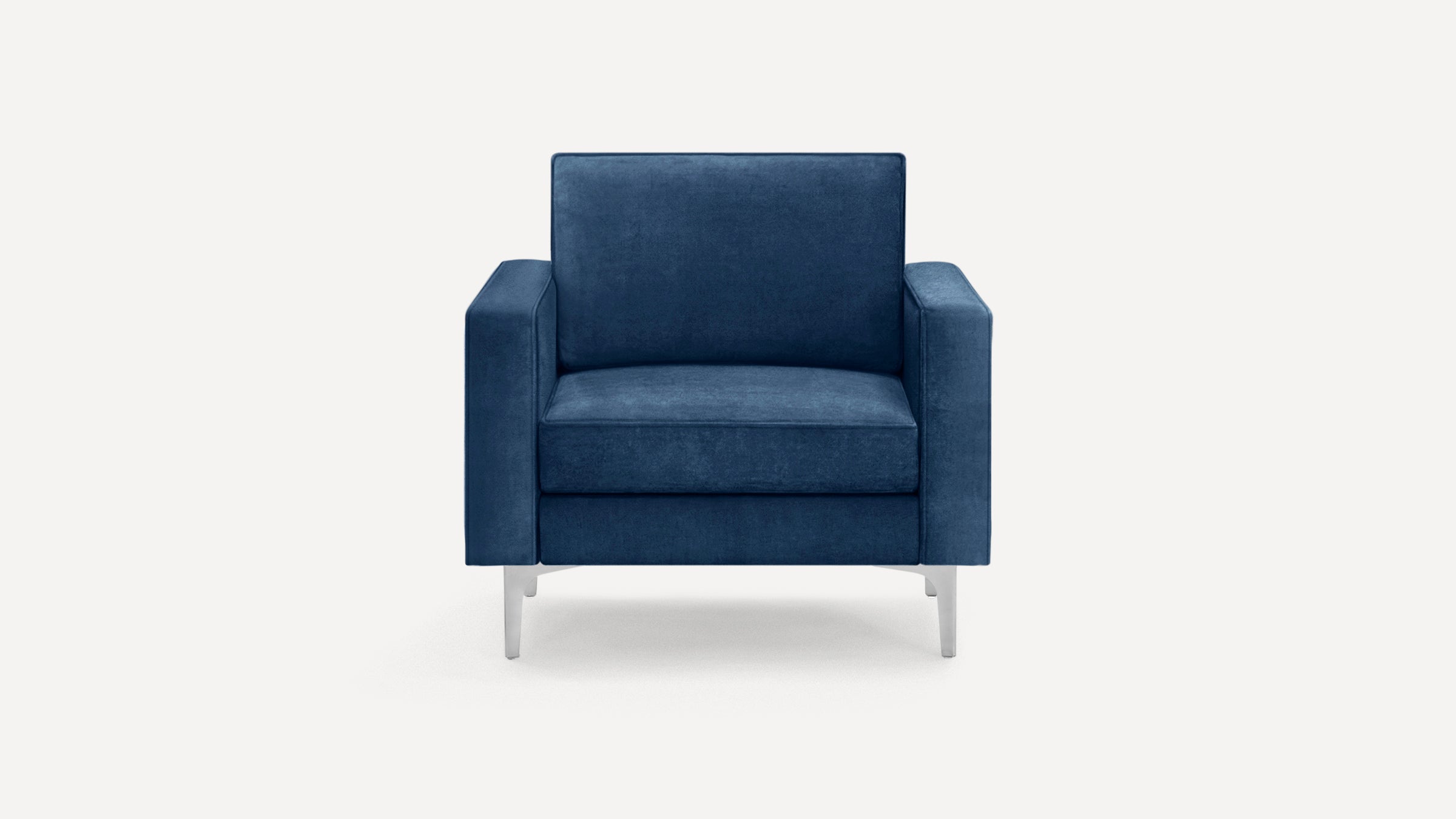 Front view of a modern navy blue velvet armchair with square arms and sleek silver metal legs.