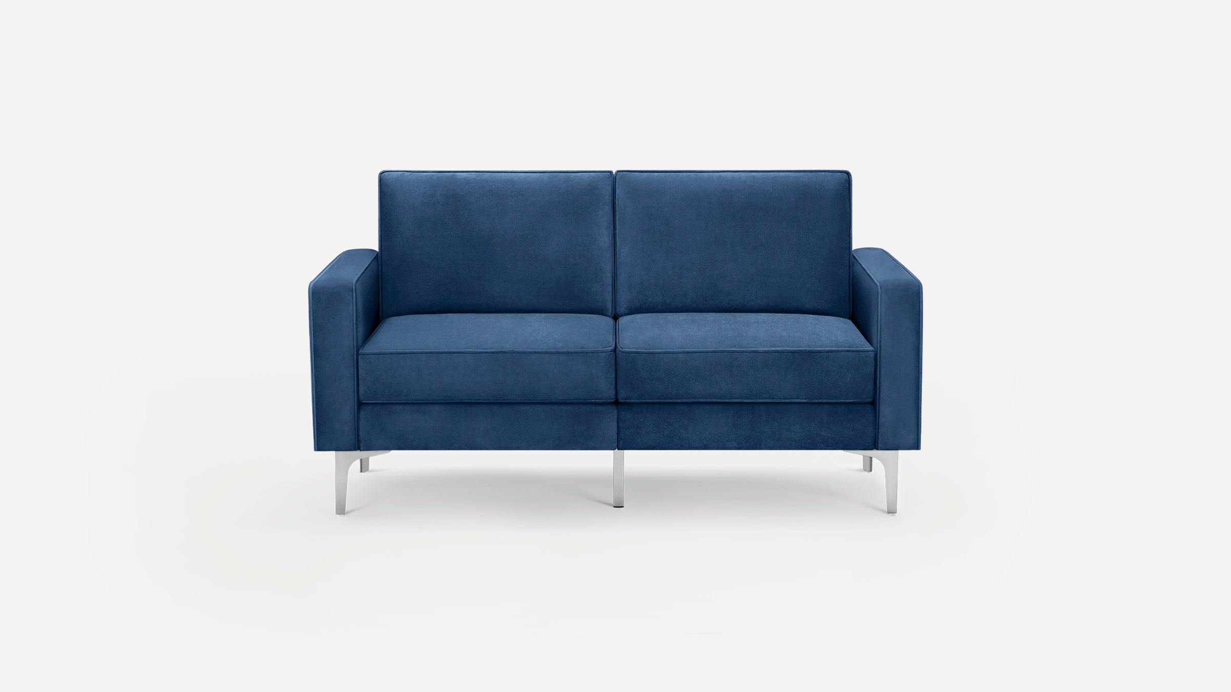 Modern two-seater sofa with deep blue velvet upholstery, square arms, and sleek silver metal legs against a white background.