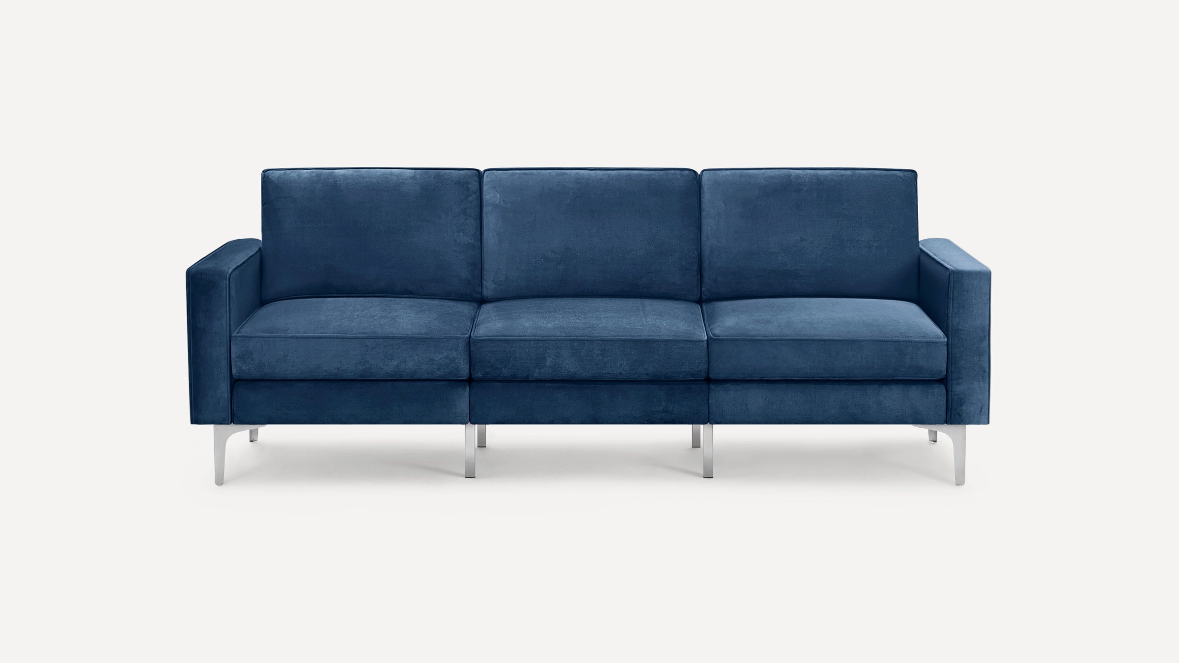 Modern three-seater sofa upholstered in deep blue velvet fabric with straight arms and sleek silver metal legs.