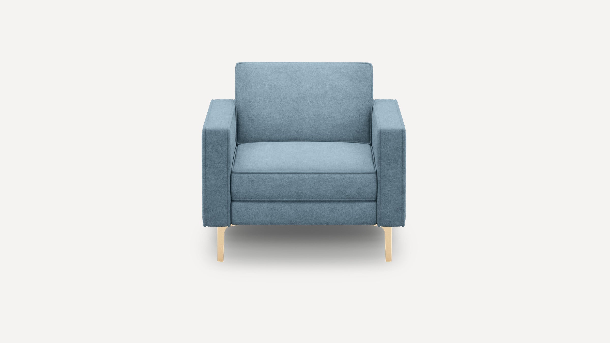 Front view of a modern blue upholstered armchair with thick cushions and light wooden legs on a white background.
