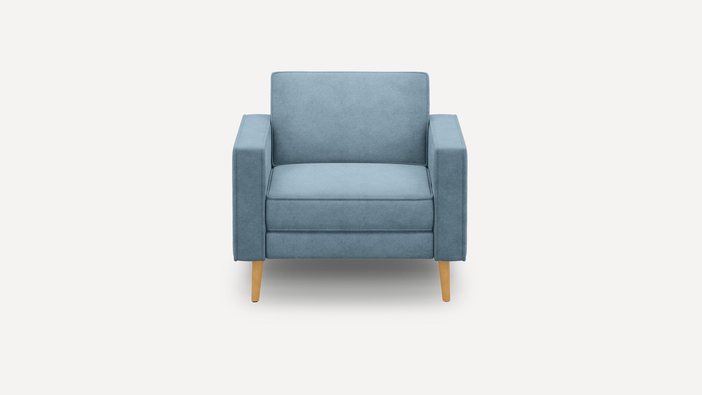 Front view of a modern, blue upholstered armchair with wooden legs on a white background.
