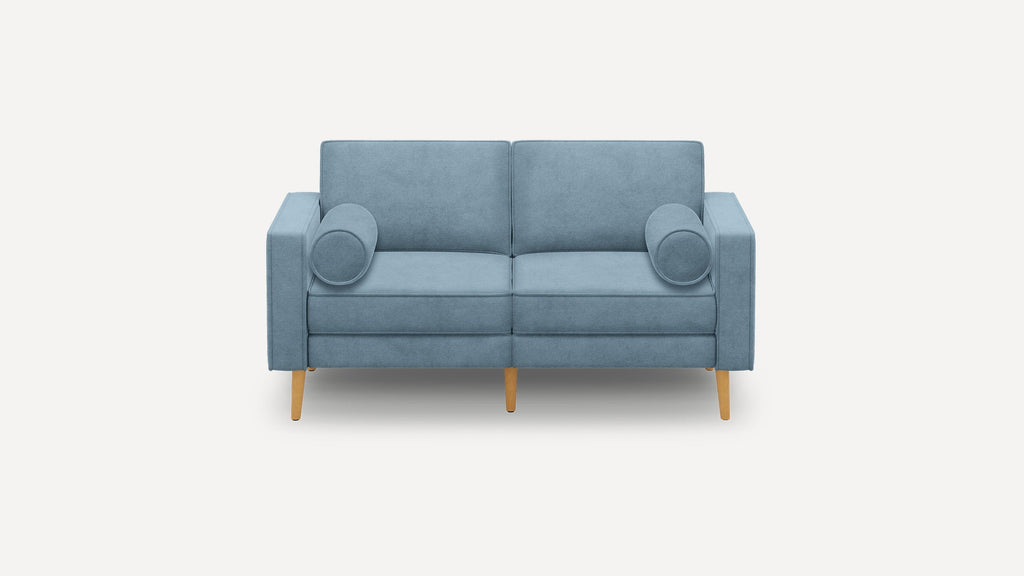 Modern blue fabric loveseat with wooden legs and two cylindrical bolster pillows on each side.