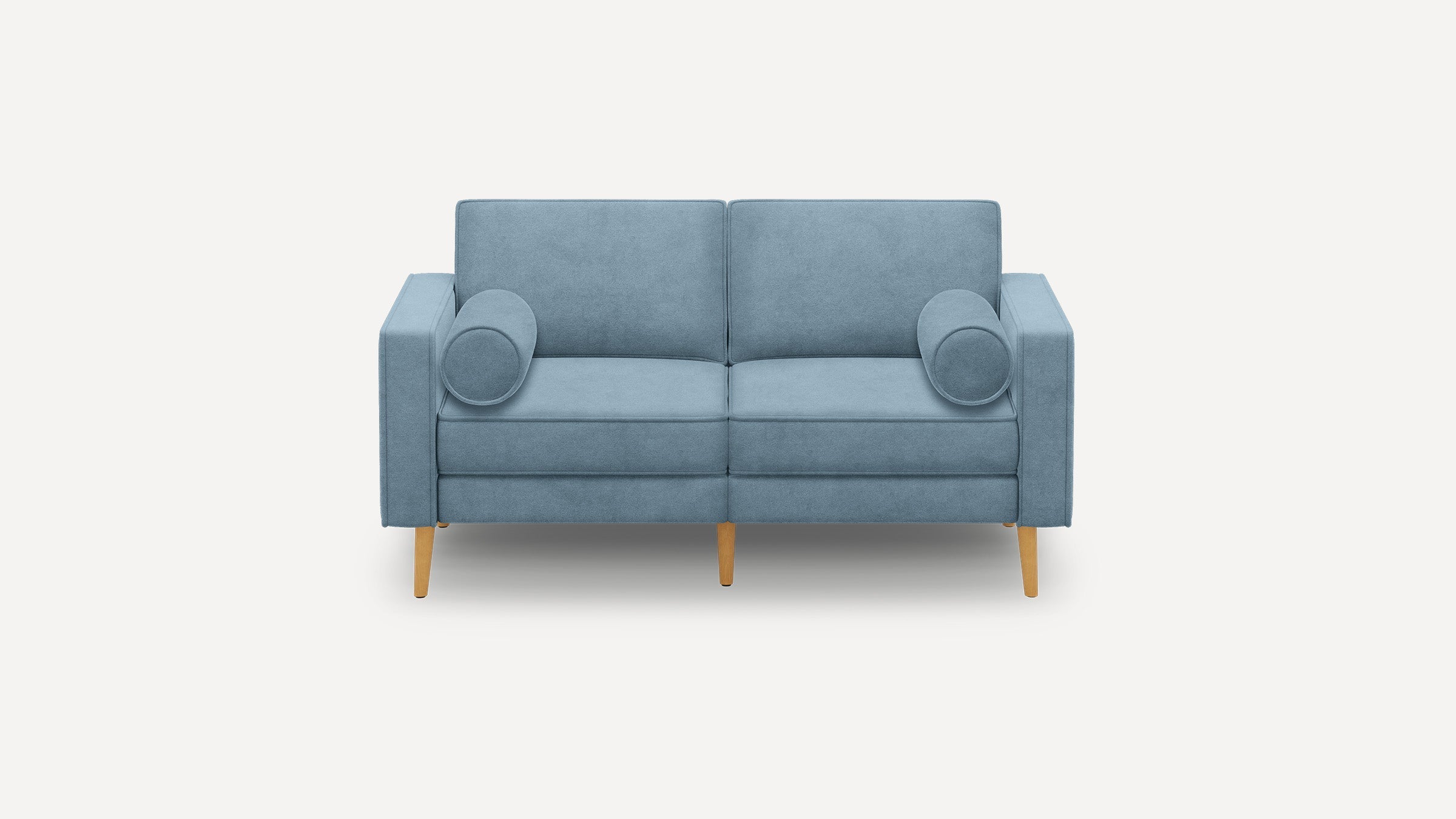 Modern blue fabric loveseat with wooden legs and two cylindrical bolster pillows on each side.