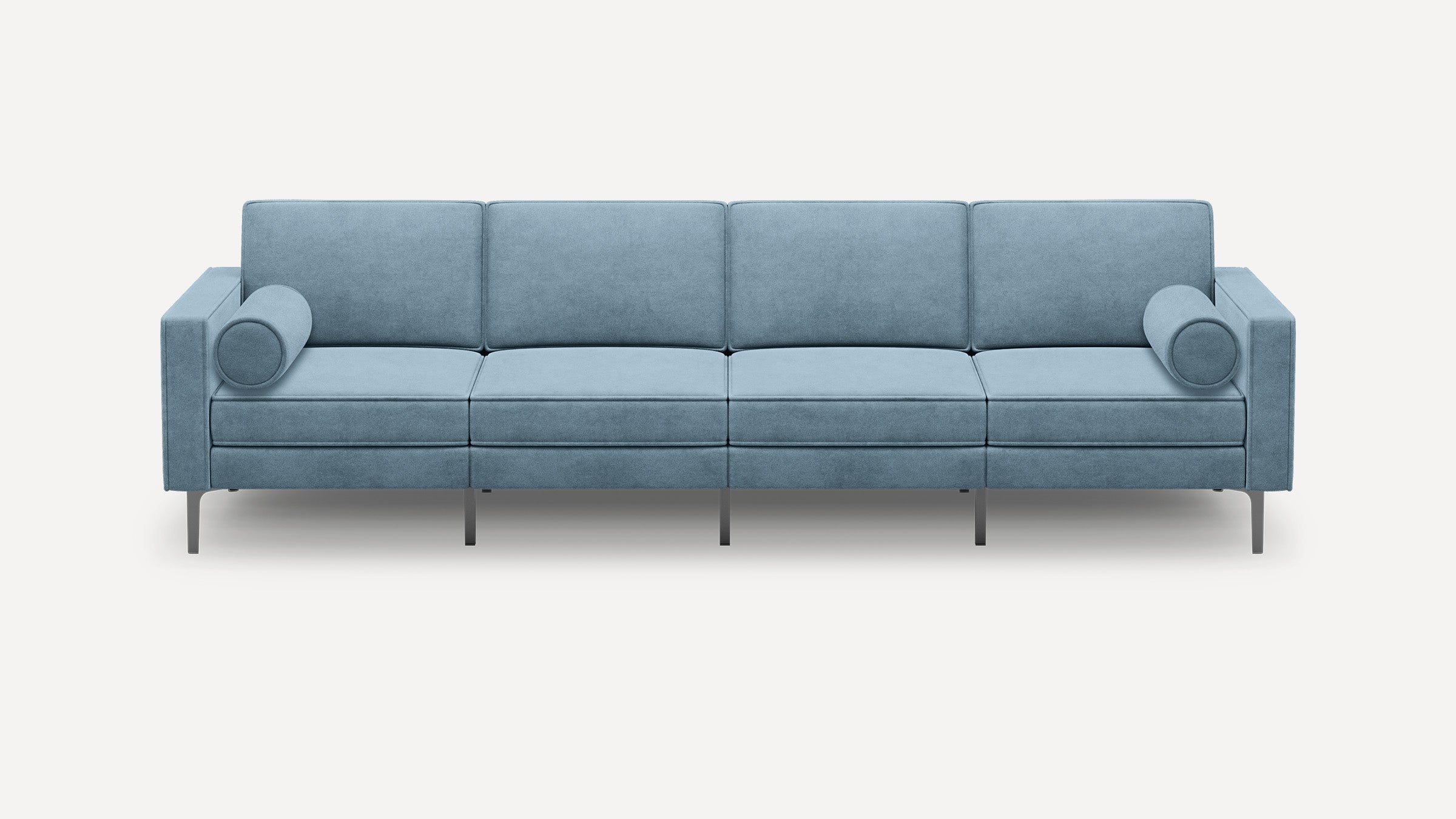 Modern light blue four-seater sofa with square arms, slim metal legs, and two cylindrical bolster pillows on each end.