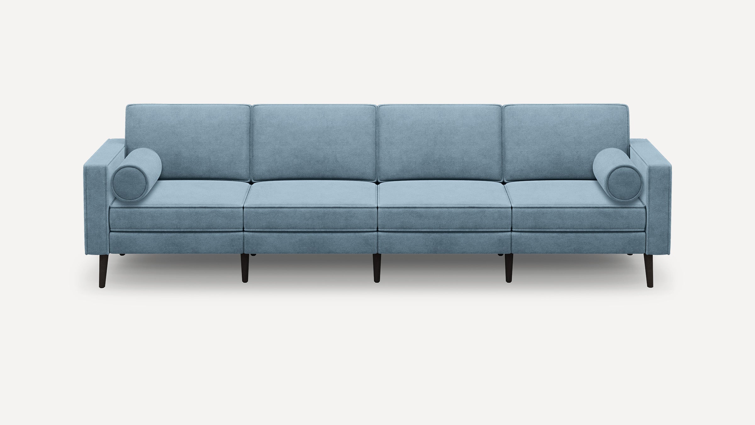 Modern light blue fabric sofa with four seat cushions, two cylindrical bolster pillows, and dark tapered wooden legs.