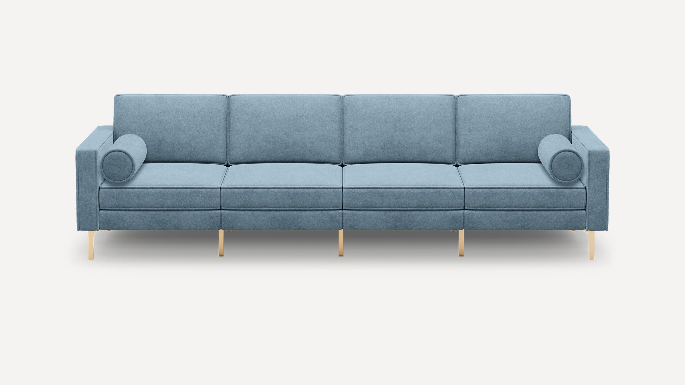 Modern four-seater sofa in light blue fabric with cylindrical bolster pillows and sleek gold metal legs.