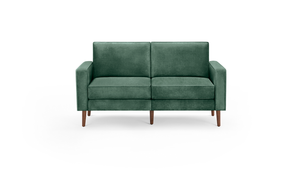 modern green velvet sofa with wooden legs and a deep cushioned seat, featuring a deep, deep - green upholstery