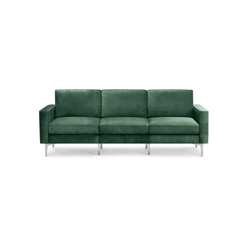 modern green velvet sofa with chrome legs and a deep green upholstery fabric sofa cushioned with a sleek design