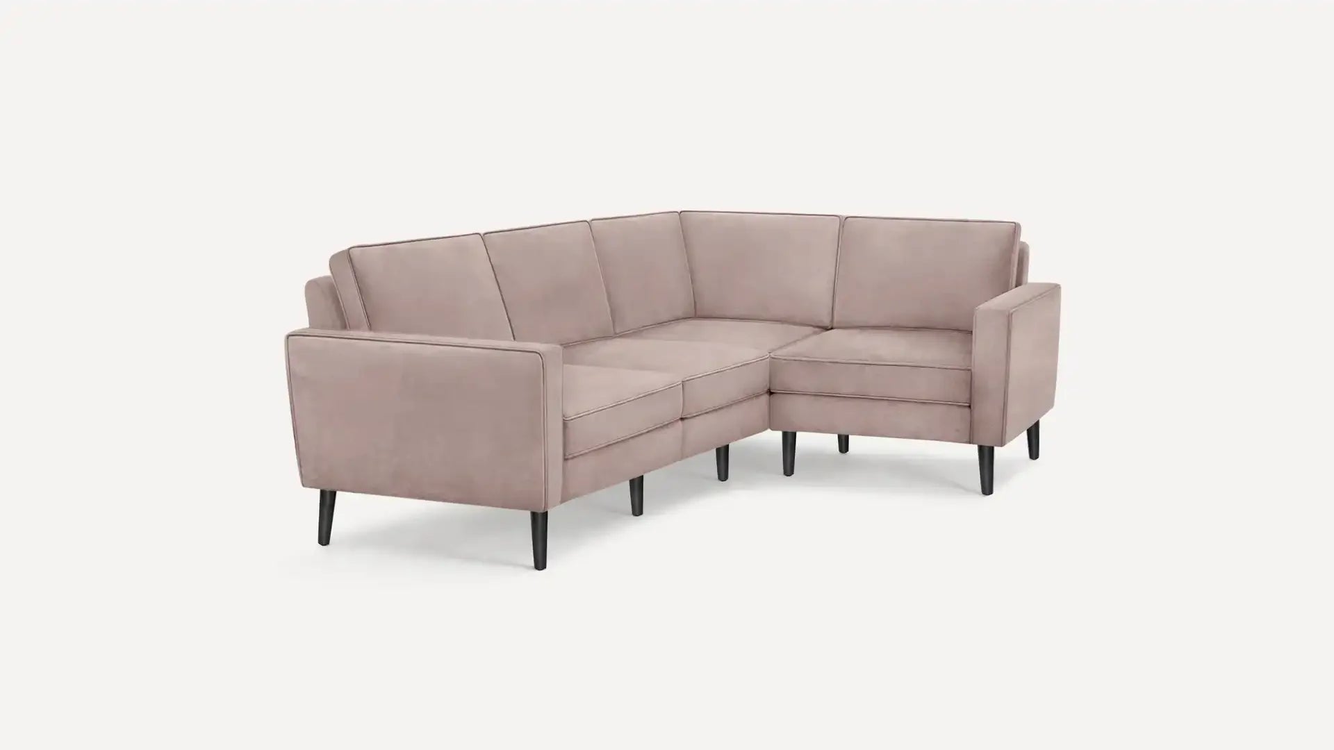 modern l - shaped sectional sofa with tufted back cushions and black tapered legs in light pink fabric