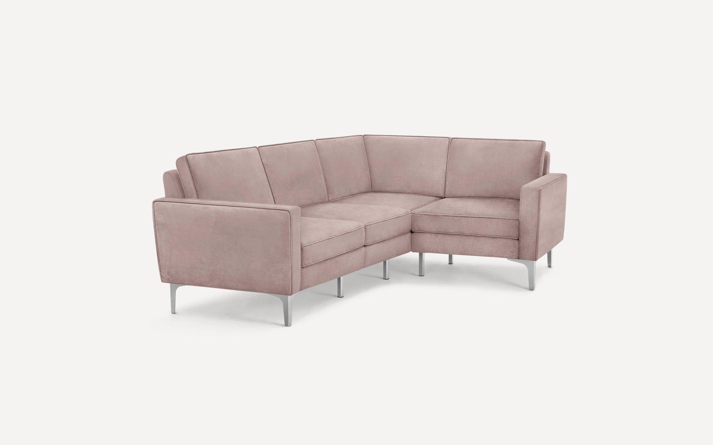 Modern L-shaped sectional sofa in muted pink fabric with slender silver metal legs and clean lines, isolated on white background.